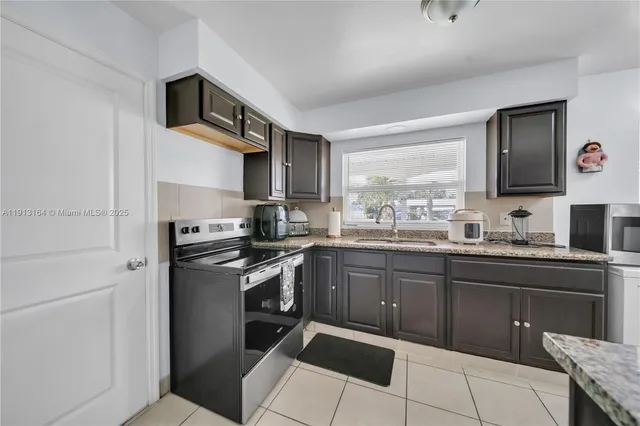 a kitchen with a sink cabinets and stainless steel appliances