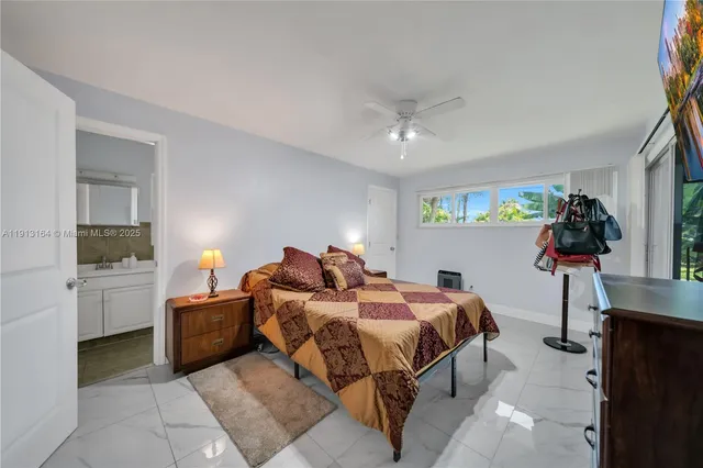 a bed room with a bed and a television