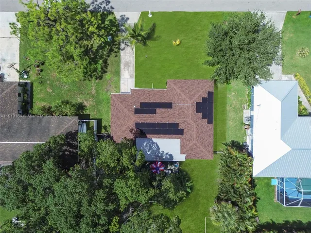 an aerial view of a house with a yard