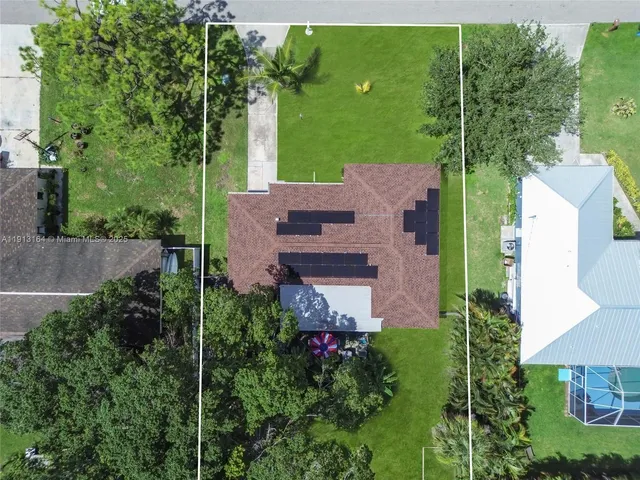an aerial view of a house with an outdoor space