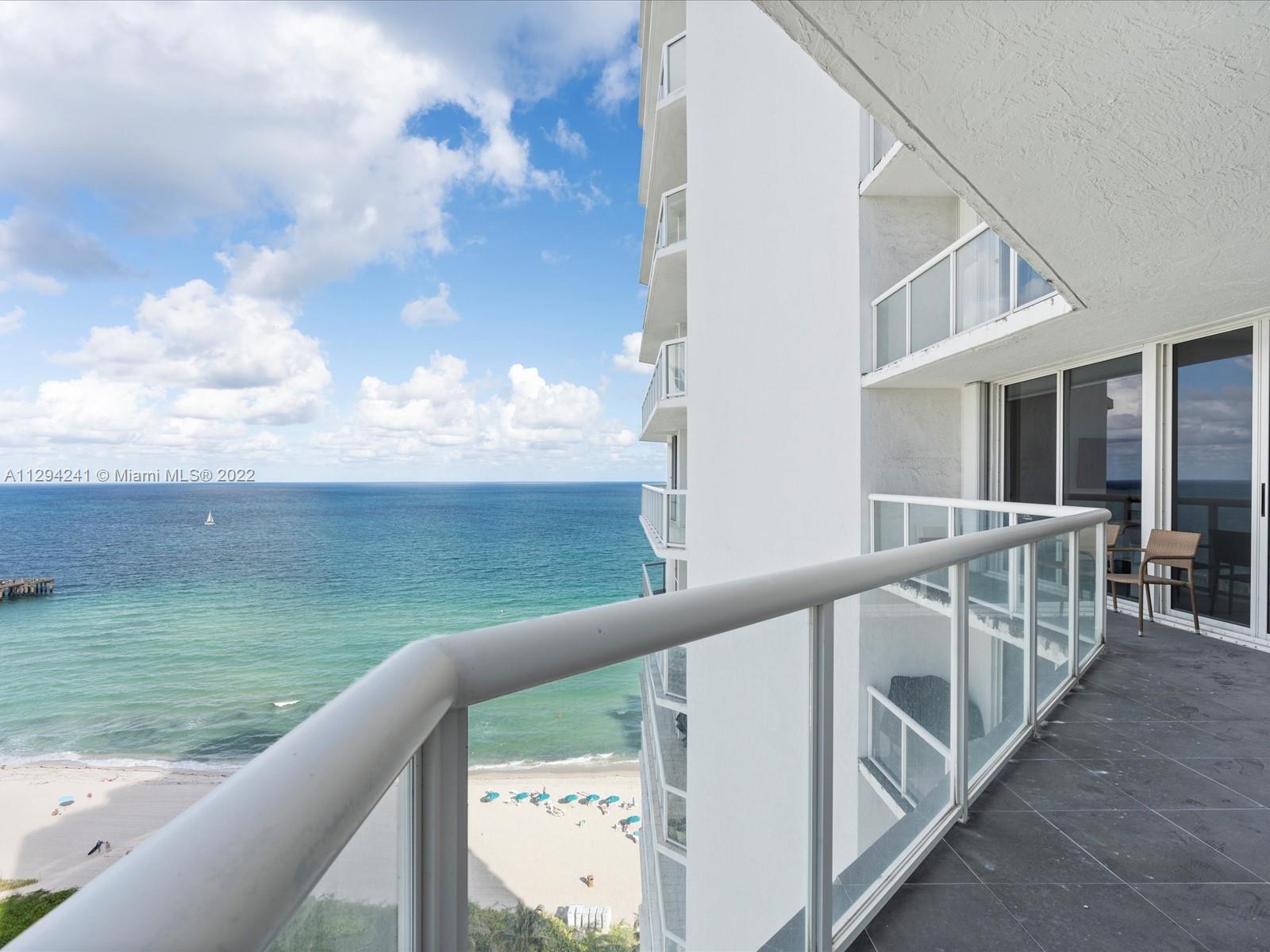 a view of a balcony with ocean view