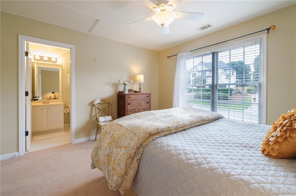 4330 Farmbrook Lane Cumming, GA 30041 - Photo 31 of 46 a bedroom with a large bed and a chandelier