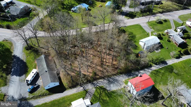 an aerial view of a house with a yard and lake view