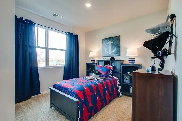 a bedroom with a bed and window