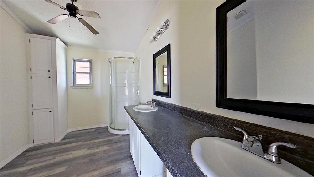 1106 Spring Flower Drive Krum, TX 76249 - Photo 16 of 22 a bathroom with a granite countertop sink and a mirror