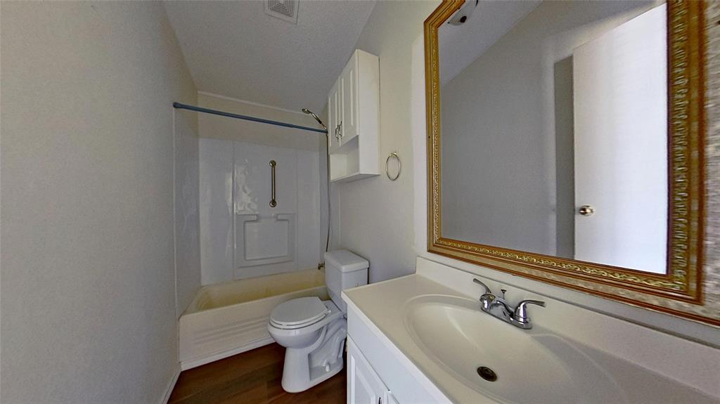 1106 Spring Flower Drive Krum, TX 76249 - Photo 18 of 22 a bathroom with a sink a toilet and shower