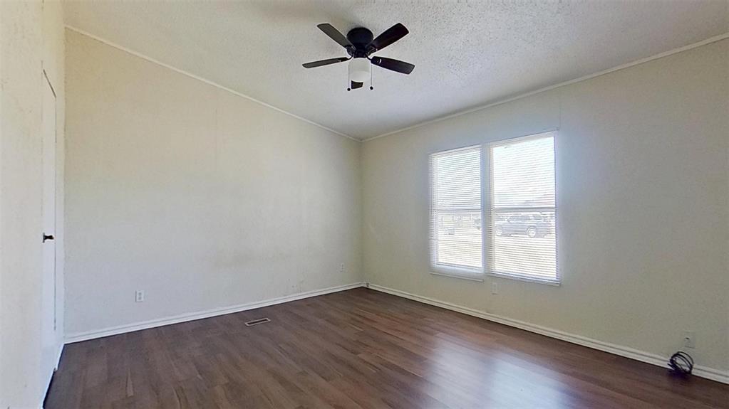 1106 Spring Flower Drive Krum, TX 76249 - Photo 19 of 22 an empty room with wooden floor and windows