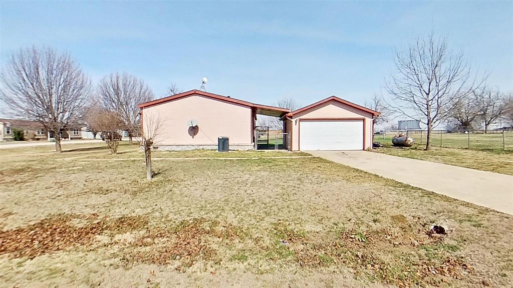 1106 Spring Flower Drive Krum, TX 76249 - Photo 20 of 22 a large house with a big yard and large trees
