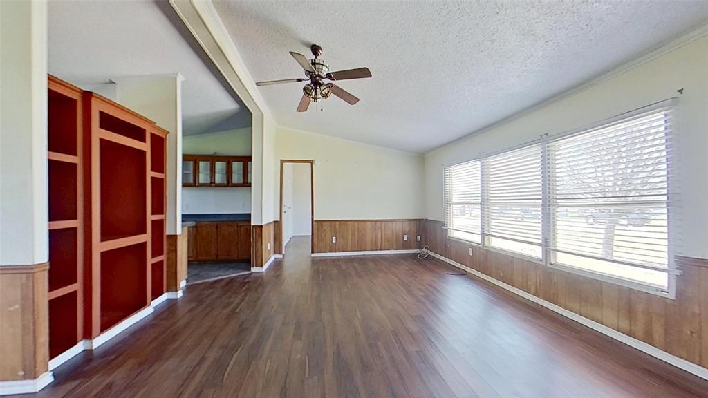 1106 Spring Flower Drive Krum, TX 76249 - Photo 7 of 22 wooden floor in an empty room with a window