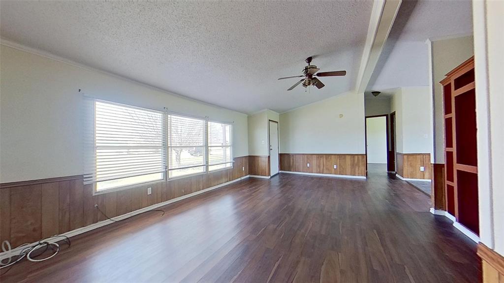 1106 Spring Flower Drive Krum, TX 76249 - Photo 10 of 22 an empty room with wooden floor and windows