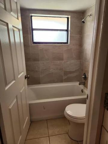 a bathroom with a toilet a bath tub and a shower