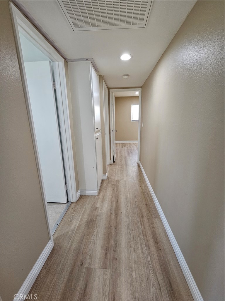 10976 Rincon Street Loma Linda, CA 92354 - Photo 11 of 12 a view of hallway with wooden floor