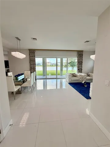 a dining room with furniture a chandelier and a rug