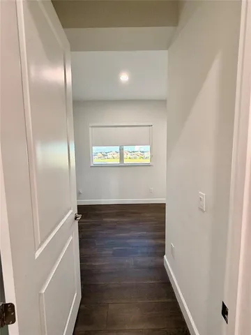 a view of a walk in closet with clothes and shoes