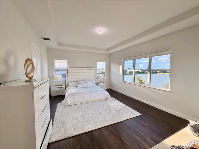 a spacious bedroom with a bed and window