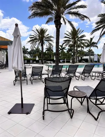 a view of swimming pool with lounge chairs