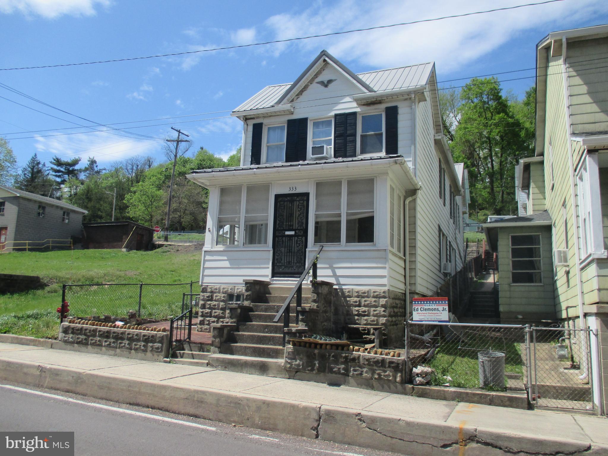 333 Pratt Street Luke, MD 21540 - Photo 2 of 42 a front view of a house with a yard