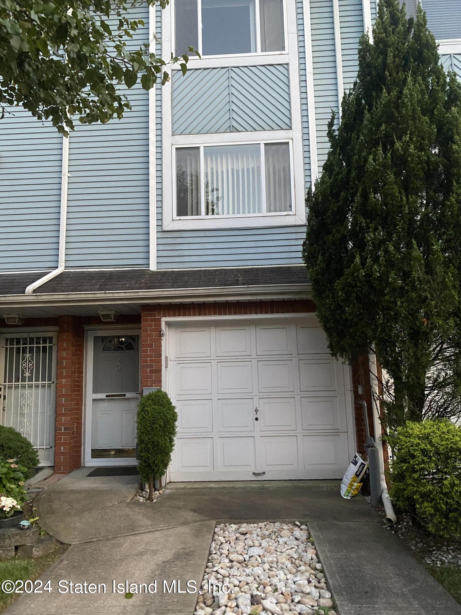 26 Pembrook Loop Staten Island, NY 10309 - Photo 4 of 4 a front view of a house with a garden