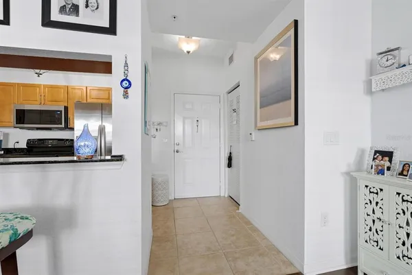 a view of a hallway with kitchen area
