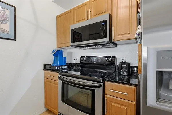 a kitchen with stainless steel appliances a stove a microwave and cabinets
