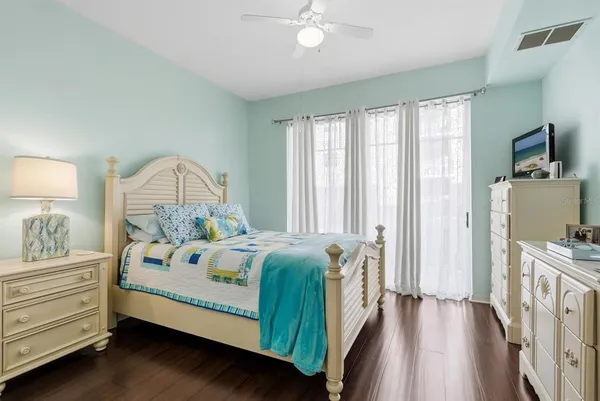 a bedroom with a bed and a chandelier