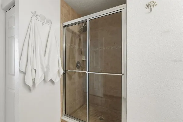 a bathroom with a glass shower door