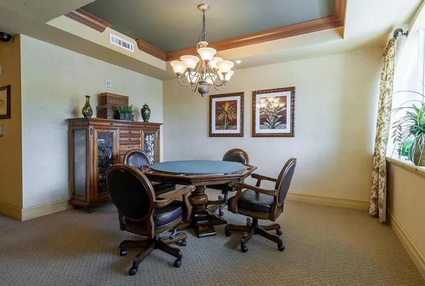a view of a dining room with furniture and a chandelier