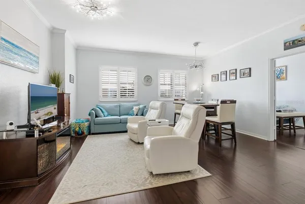 a living room with furniture wooden floor and a flat screen tv