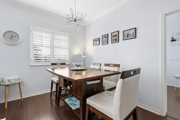 a view of a dining room with a table and chairs