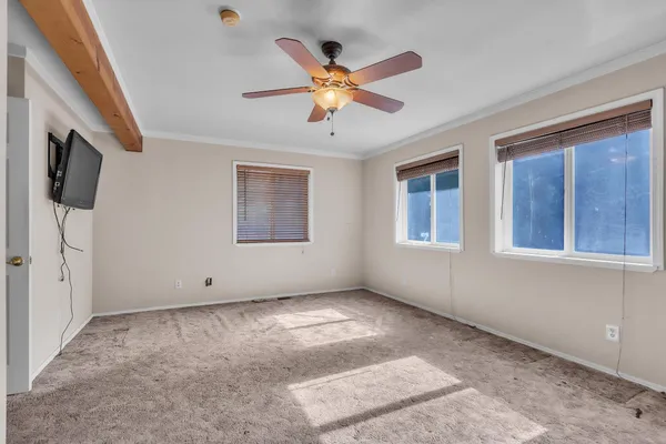 a view of a livingroom with a ceiling fan and wooden floor