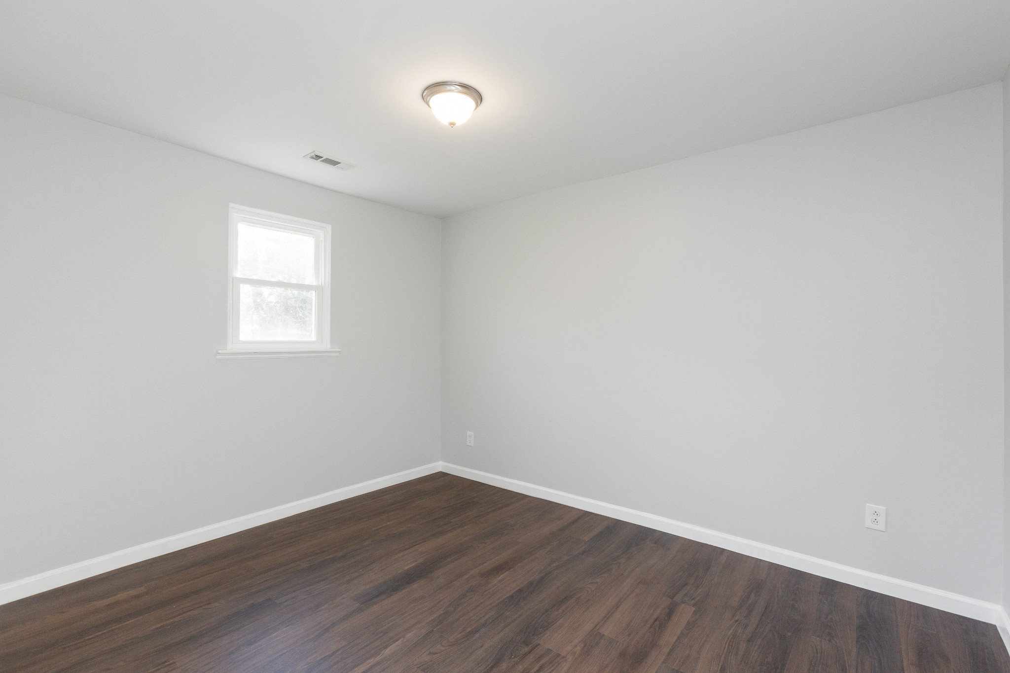 6169 Highway 76 Springfield, TN 37172 - Photo 18 of 34 a view of an empty room with wooden floor and a window