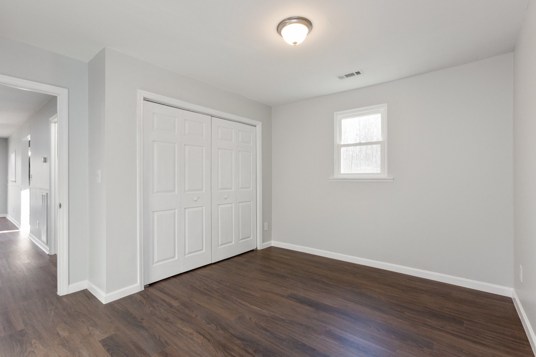 6169 Highway 76 Springfield, TN 37172 - Photo 19 of 34 a view of an empty room with wooden floor and a window
