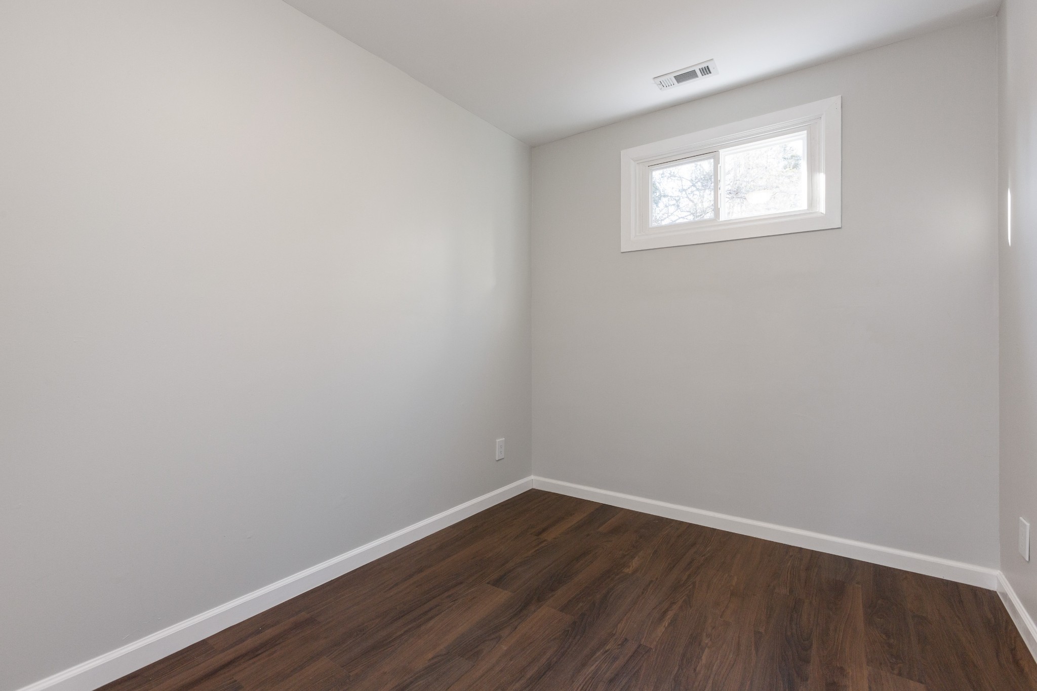 6169 Highway 76 Springfield, TN 37172 - Photo 21 of 34 a view of an empty room with wooden floor and a window