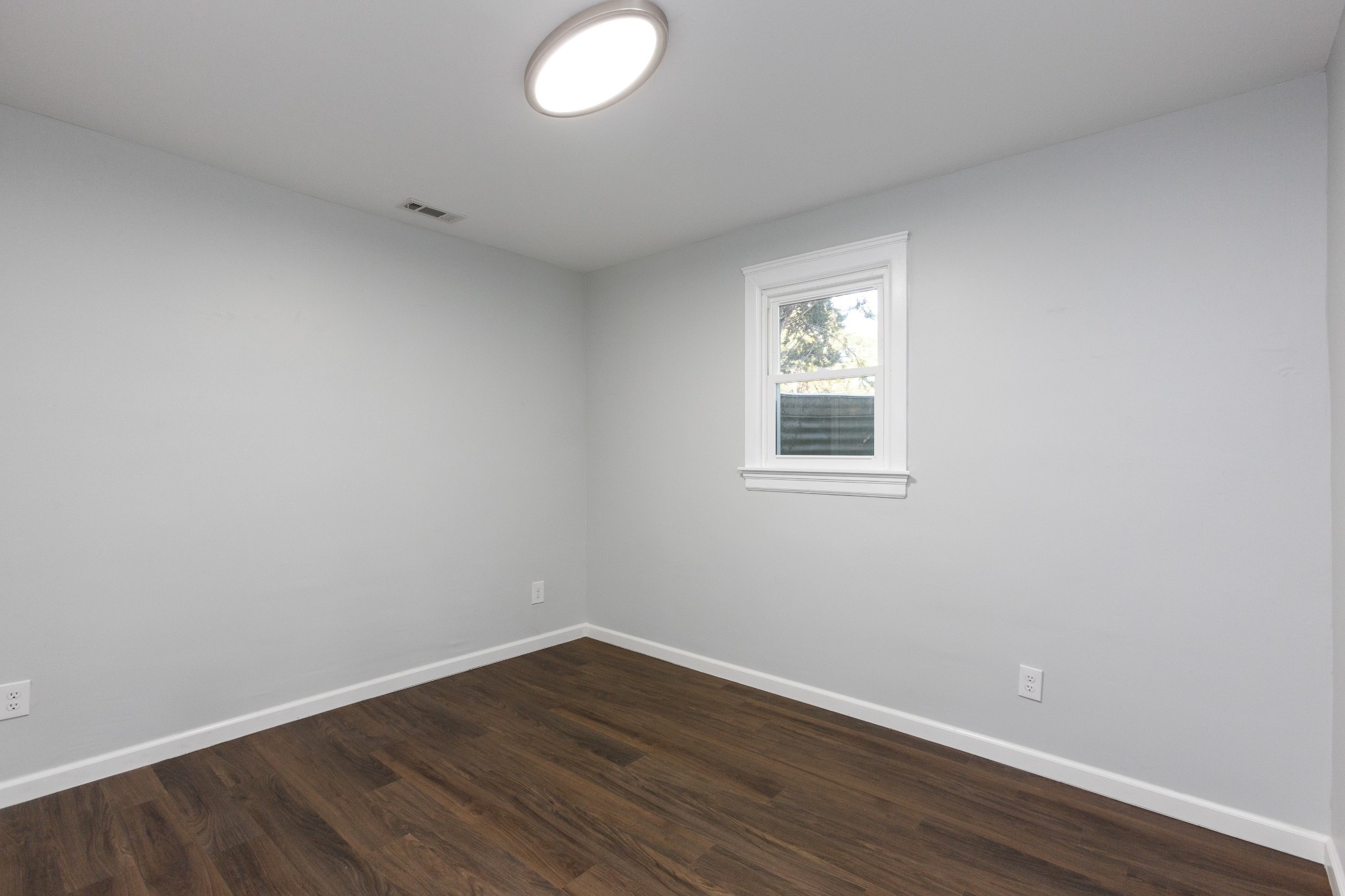 6169 Highway 76 Springfield, TN 37172 - Photo 24 of 34 an empty room with wooden floor and windows