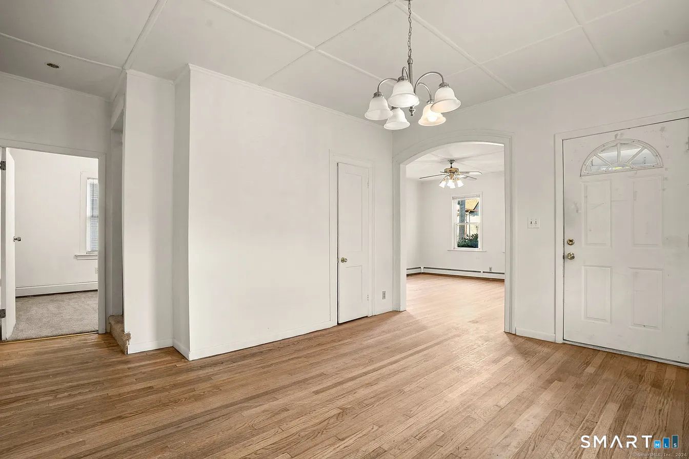 25 Pleasant Street Ansonia, CT 06401 - Photo 14 of 16 a view of an empty room with wooden floor