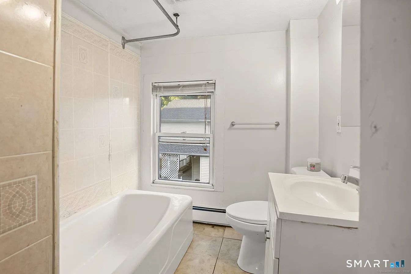 25 Pleasant Street Ansonia, CT 06401 - Photo 15 of 16 a bathroom with a sink toilet and shower