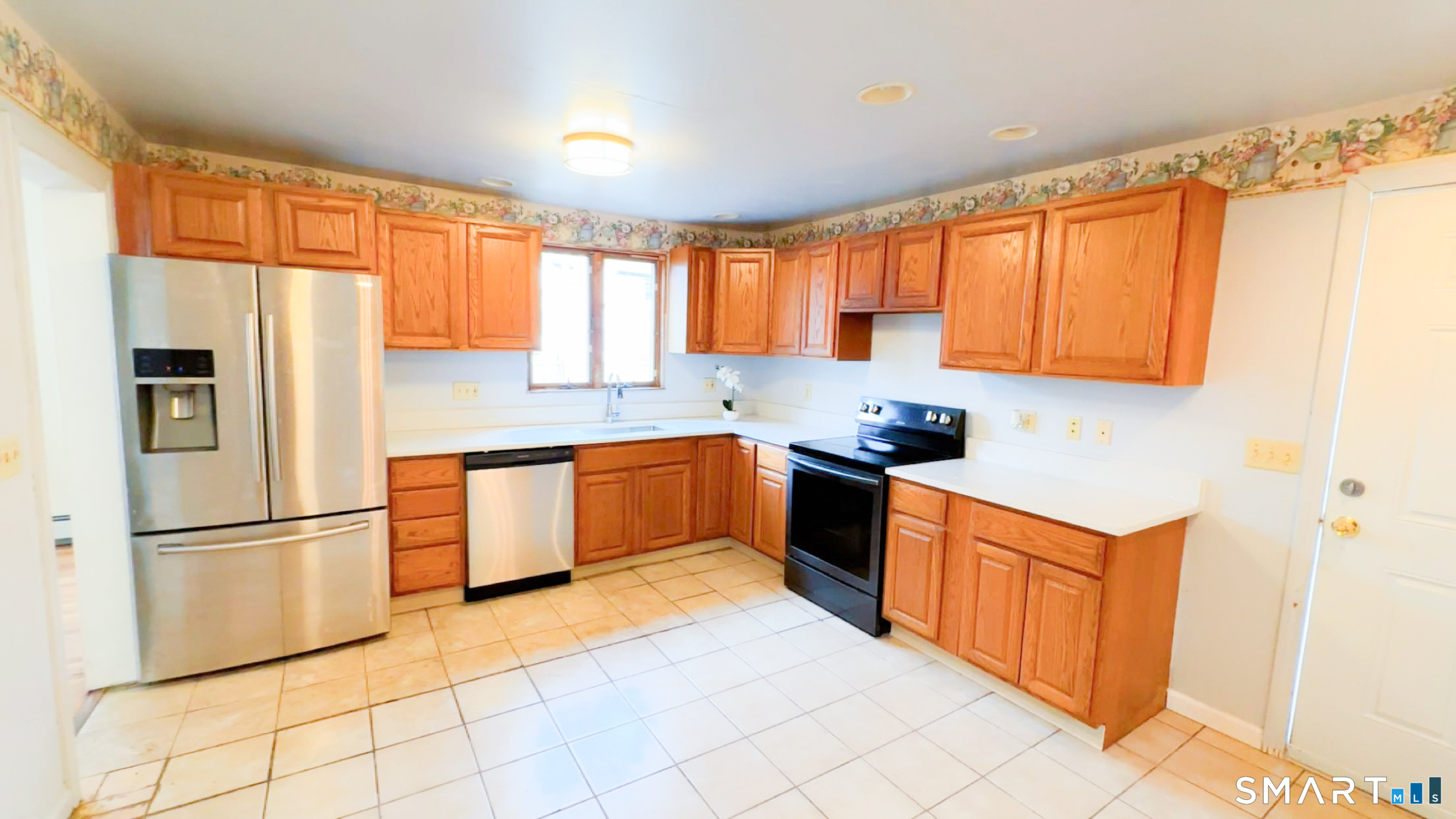 25 Pleasant Street Ansonia, CT 06401 - Photo 4 of 16 a kitchen with stainless steel appliances granite countertop a refrigerator a sink dishwasher a stove with white cabinets and wooden floor