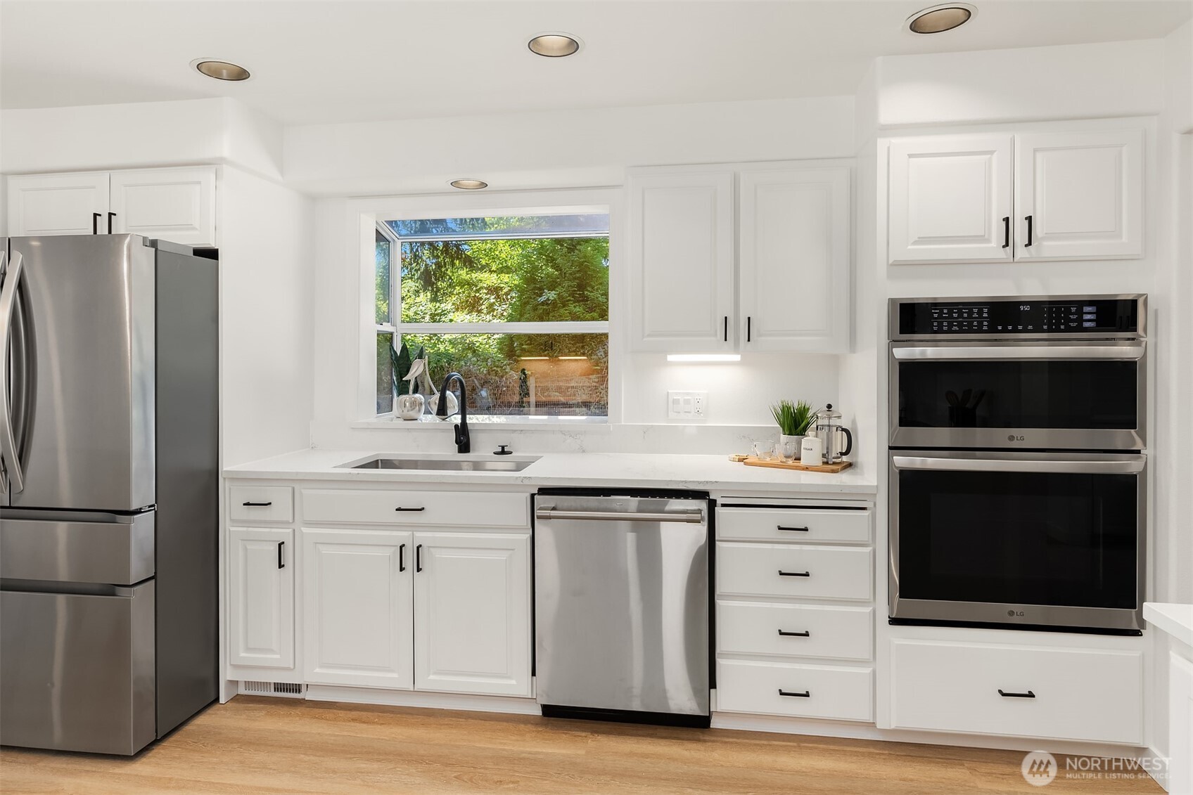 22918 49th Avenue Southeast Bothell, WA 98021 - Photo 14 of 38 a kitchen with stainless steel appliances white cabinets and a refrigerator