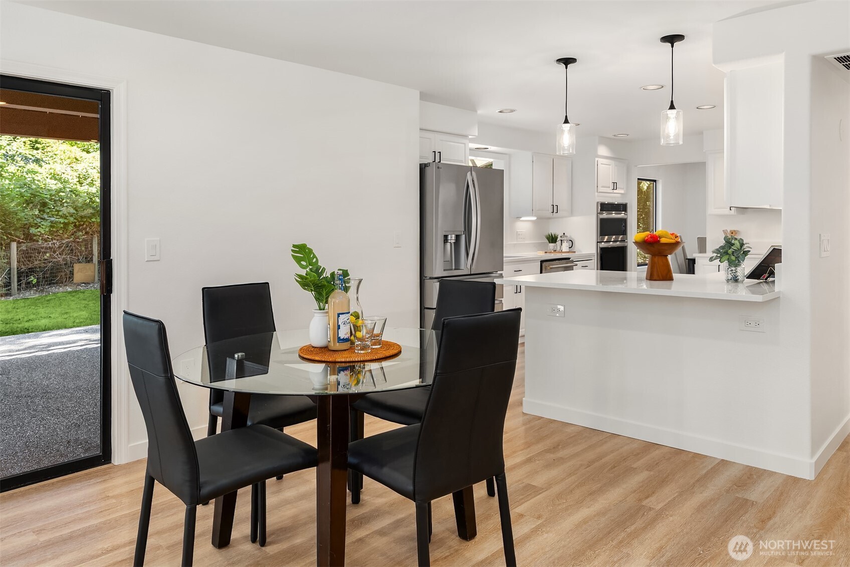 22918 49th Avenue Southeast Bothell, WA 98021 - Photo 10 of 38 a view of a dining room and livingroom with furniture wooden floor a rug a potted plant and a chandelier