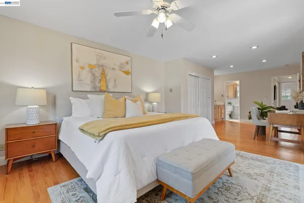 a spacious bedroom with a bed and a cabinets