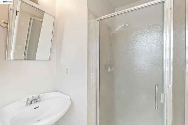 a bedroom with a bed and a lamp