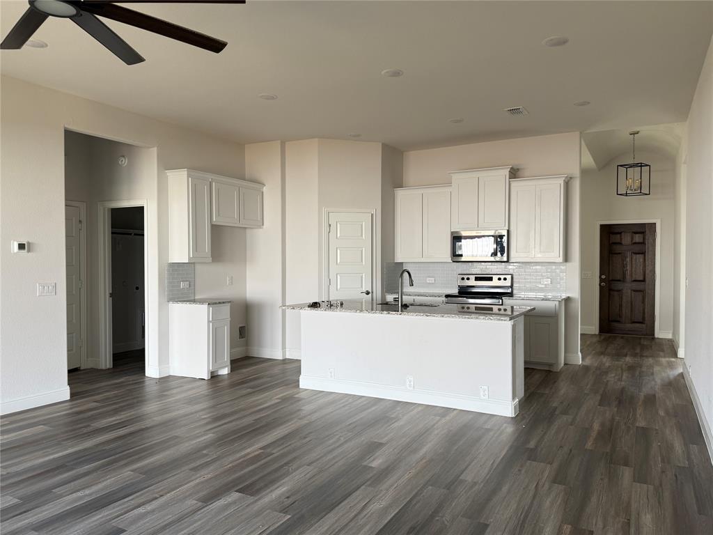 502 Second Street Venus, TX 76084 - Photo 3 of 5 a kitchen with a refrigerator and white cabinets