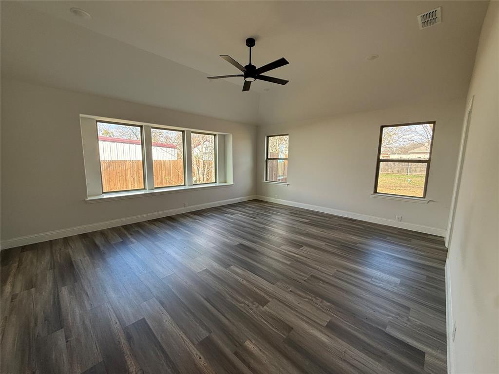 502 Second Street Venus, TX 76084 - Photo 4 of 5 a view of an empty room with wooden floor and a window