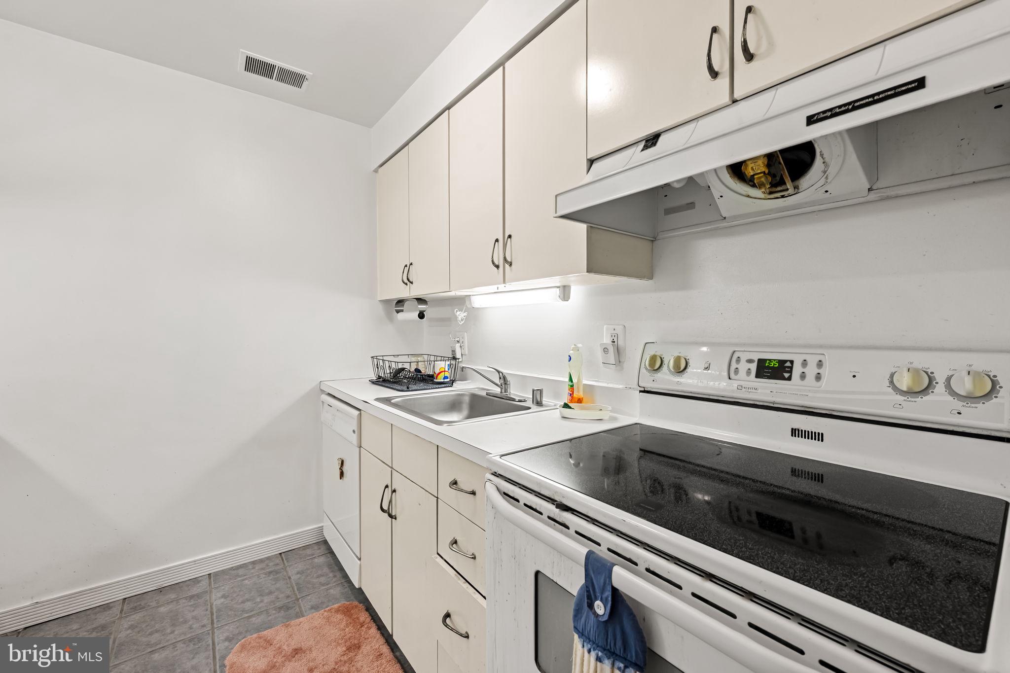 526 South Charles Street, Unit R79 Baltimore, MD 21201 - Photo 11 of 21 a kitchen with a stove and white cabinets