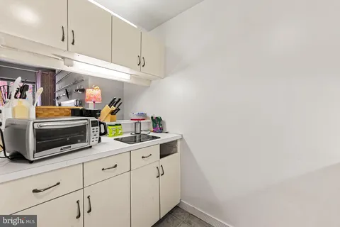 a kitchen with cabinets and window