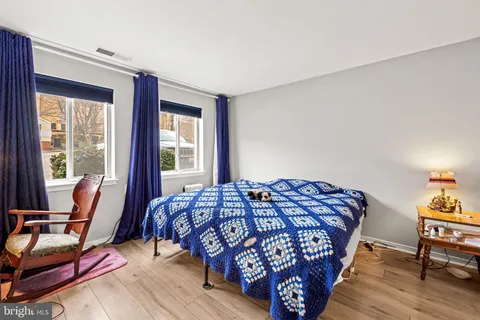 a bedroom with a bed and wooden floor