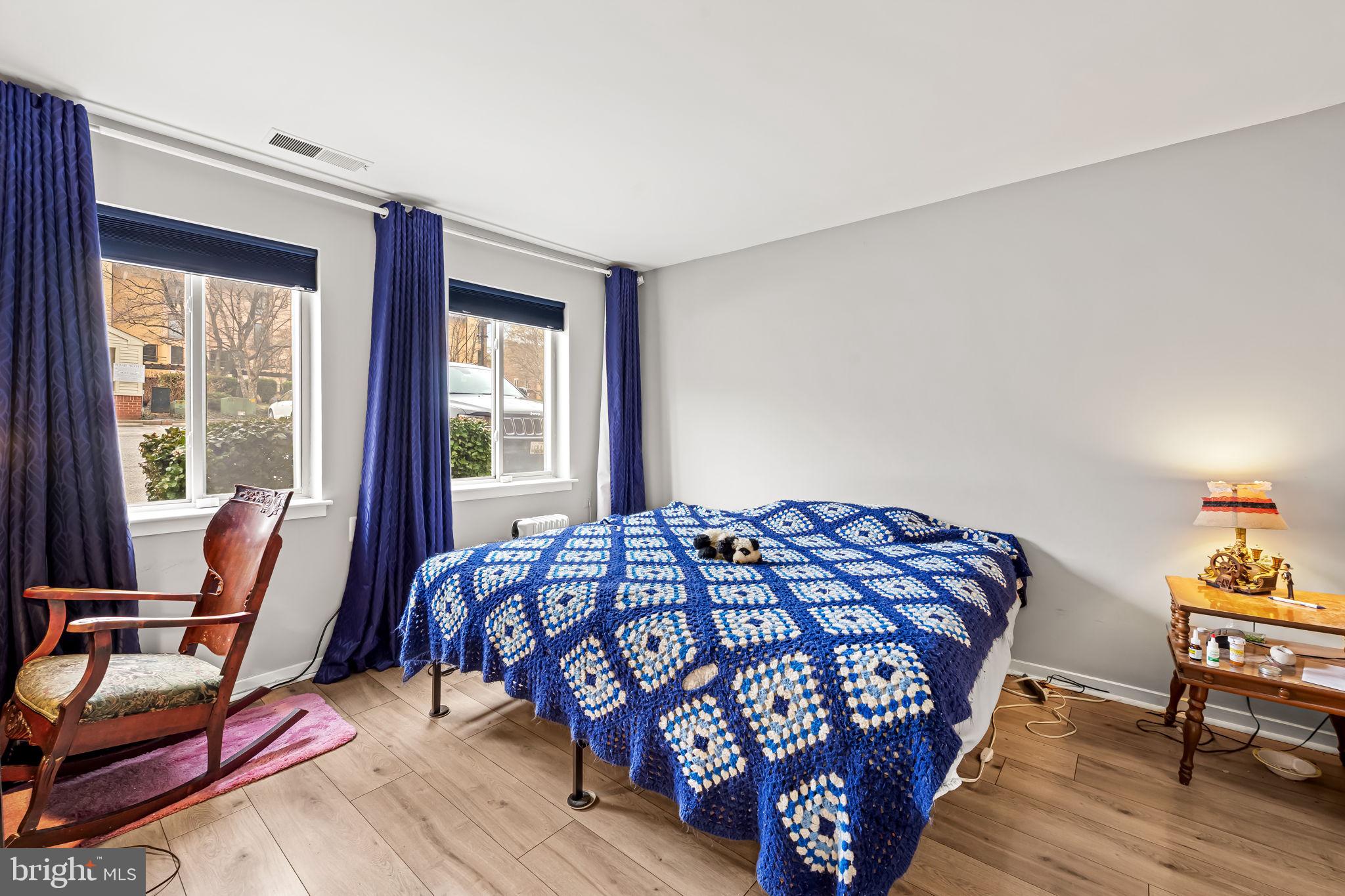 526 South Charles Street, Unit R79 Baltimore, MD 21201 - Photo 14 of 21 a bedroom with a bed and wooden floor