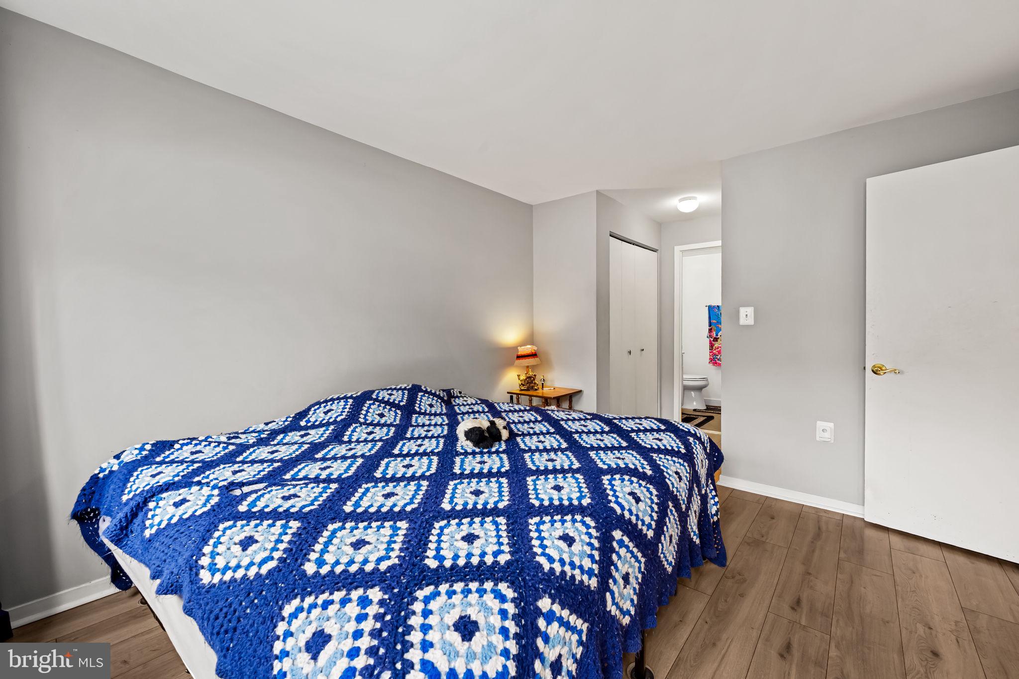 526 South Charles Street, Unit R79 Baltimore, MD 21201 - Photo 15 of 21 a bedroom with a bed and wooden floor