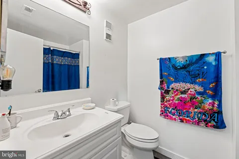 a bathroom with a sink mirror and toilet