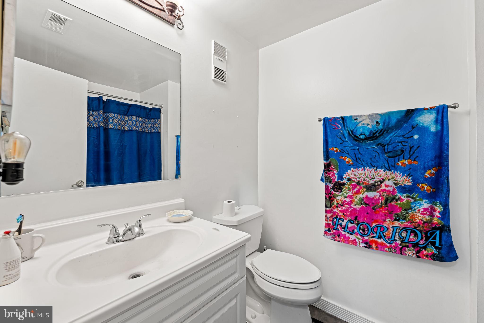 526 South Charles Street, Unit R79 Baltimore, MD 21201 - Photo 17 of 21 a bathroom with a sink mirror and toilet
